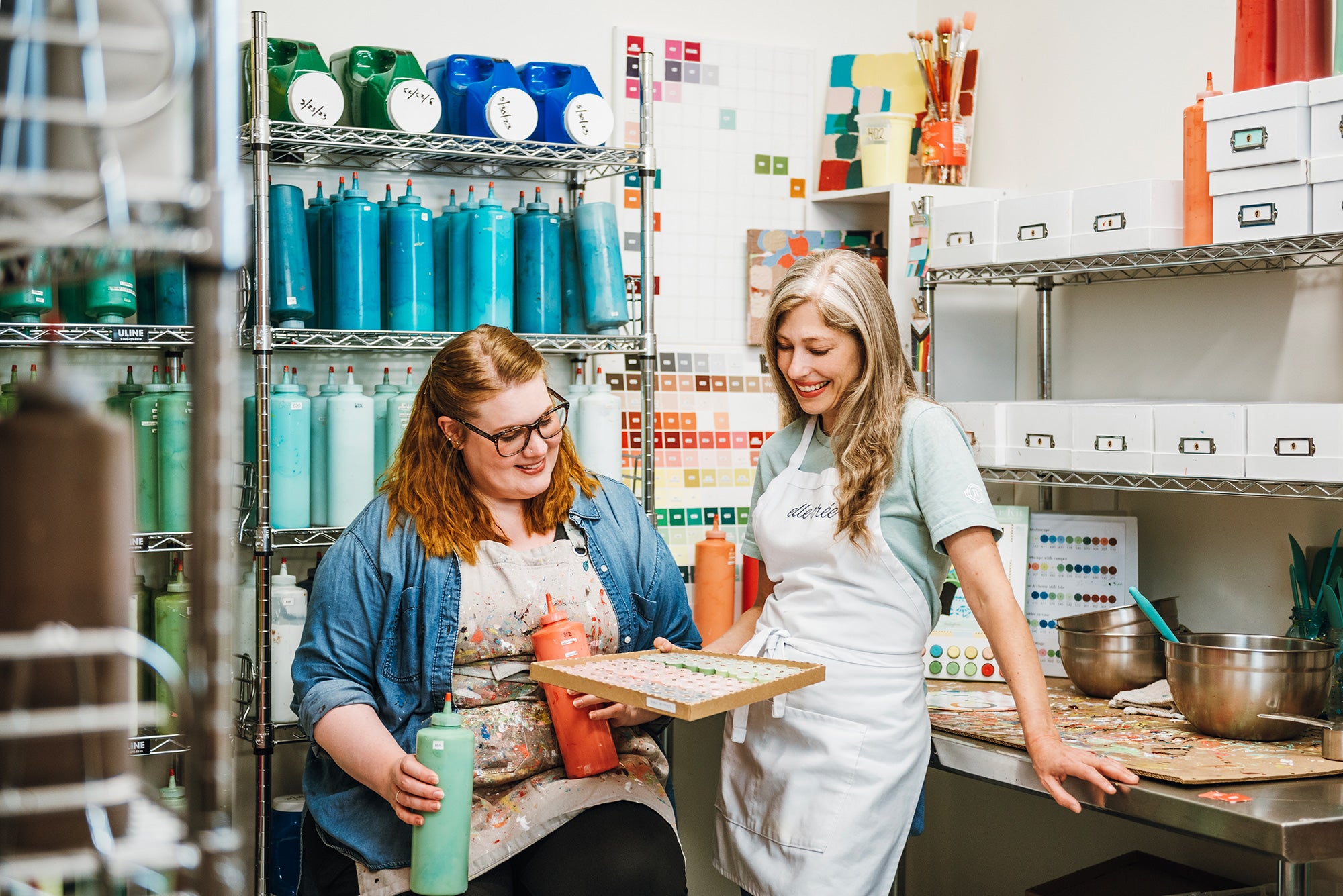 The designer and color specialist at Elle Crée inside their paint room working.