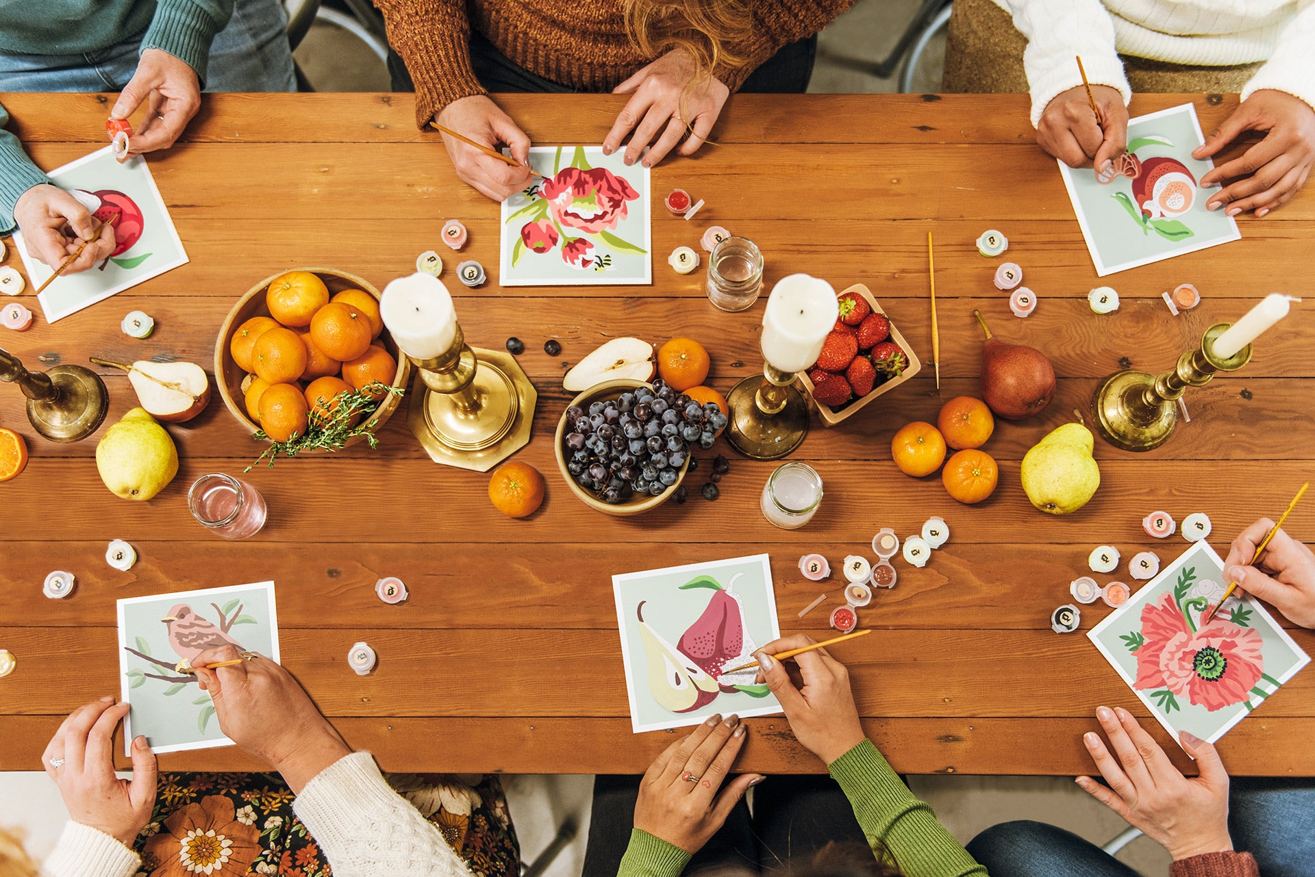 6 mini paint-by-number kits being painted: Sparrow, Pears, Poppies, Apples, Peonies, and Clementines