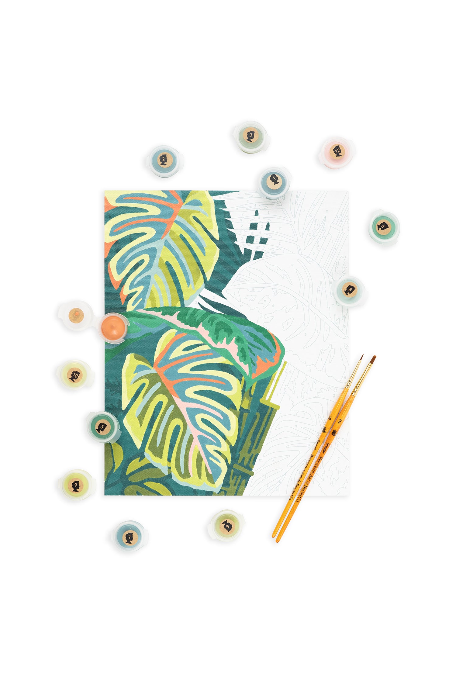 Vintage Verde paint-by-number kit with tropical leaf design, 12 acrylic paint pots, and two paintbrushes on white background.