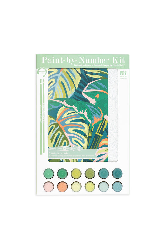 Vintage Verde paint-by-number kit packaging featuring tropical leaf artwork, 12 acrylic paint colors, and brushes, designed by Elle Crée.