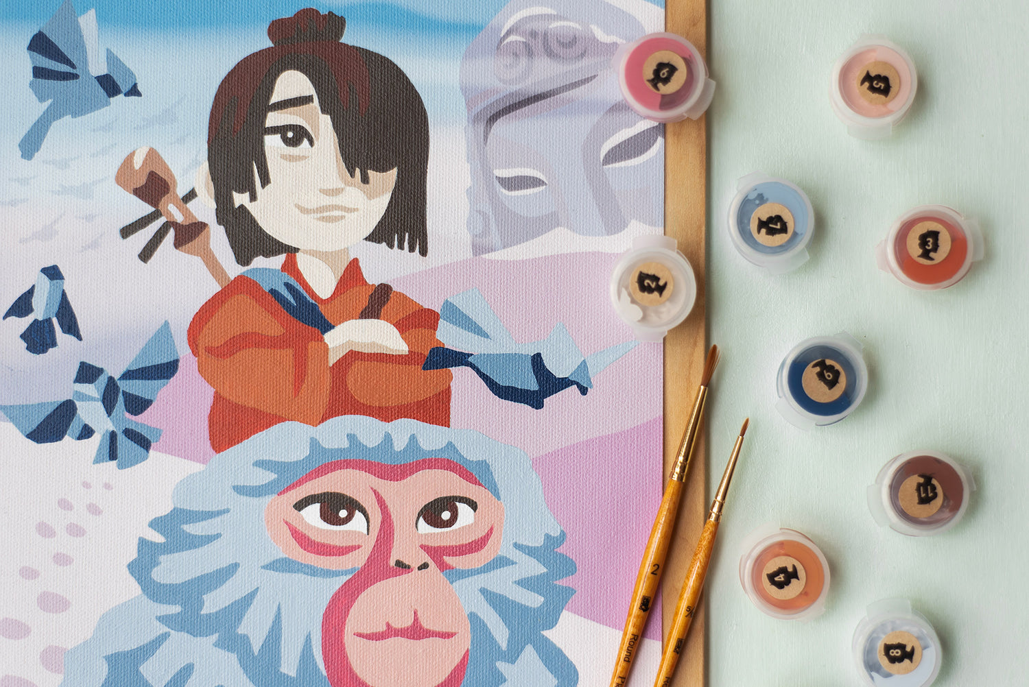 Close up shot of the Kubo and Monkey from Kubo and the Two Strings paint-by-number kit made in collaboration with Elle Crée and LAIKA Studios.