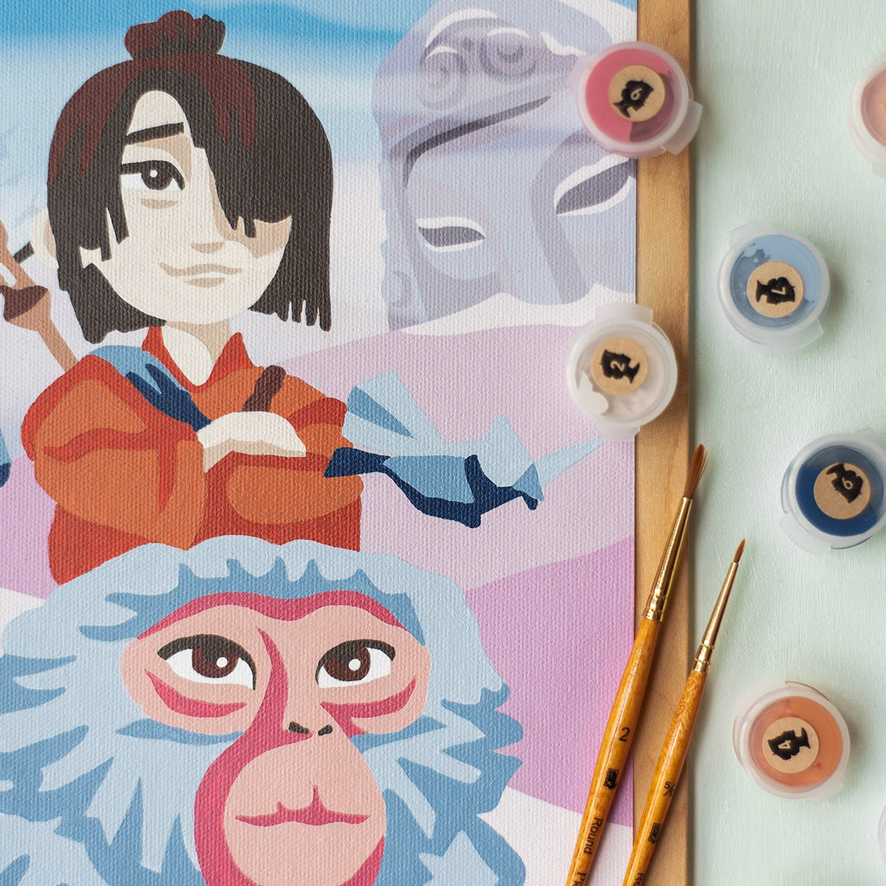 Close up shot of the Kubo and Monkey from Kubo and the Two Strings paint-by-number kit made in collaboration with Elle Crée and LAIKA Studios.